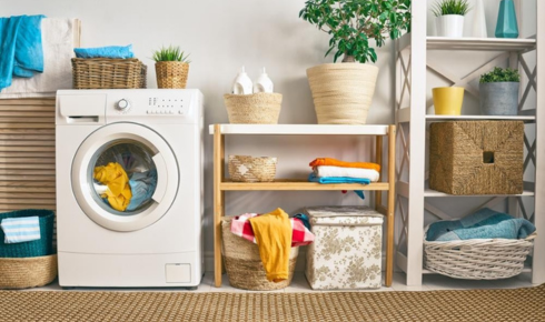 How can having a small laundry basket in each bedroom reduce clothes piles on floors?
