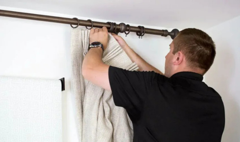 How can tightening loose curtain brackets early stop damage to walls later?