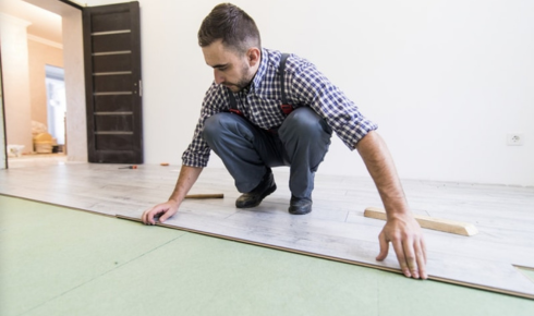 What advantage is there in asking contractors to protect existing floors before heavy work begins