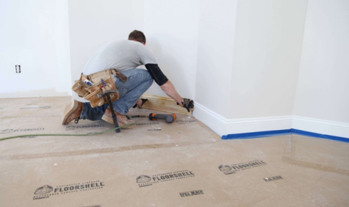  What advantage is there in asking contractors to protect existing floors before heavy work begins
