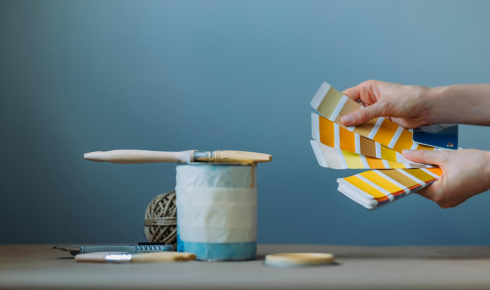 Why is it smart to test paint samples in both daytime and artificial light before deciding