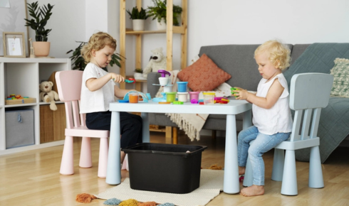 Why is it useful to think about whether kids will play on the floor before choosing very hard surfaces